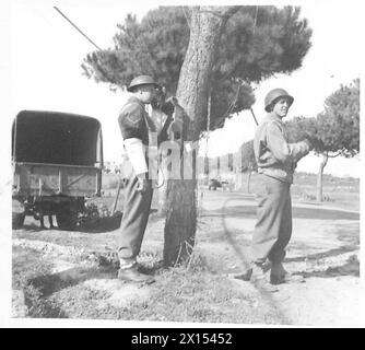 FIFTH ARMY : ANZIO BRIDGEHEAD - British and American Military Policemen have in some instances been 'teamed up' to cope with the mixed traffic conditions on the bridgehead. L/Cpl. J. James, 1st Br.Division, Provost of Gosport Road, Walthamstow, E.17 on duty with Pfc. Arthur L. Leblang of Yonkers, New York British Army Stock Photo