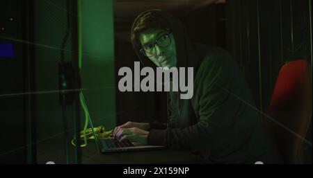 Image of data processing over asian male hacker in server room Stock Photo