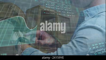 Image of financial data and graphs over midsection of caucasian businessman using smartwatch Stock Photo