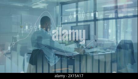 Image of financial data processing over african amercian businessman in office Stock Photo