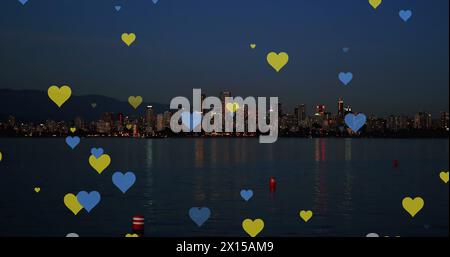 Image of yellow and blue hearts floating over night cityscape Stock ...