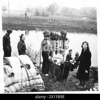 British Army personnel erect a raft to ferry an anti-tank gun and men ...