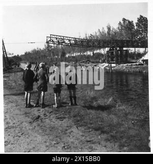 BRIDGING: 49 DIV. 1ST. CORPS B.L.A. - Young Belgians watch the progress of the bridge British Army, 21st Army Group Stock Photo