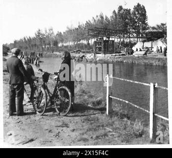 BRIDGING: 49 DIV. 1ST. CORPS B.L.A. - Interested Belgians watch the great bridge as it starts on its way across British Army, 21st Army Group Stock Photo