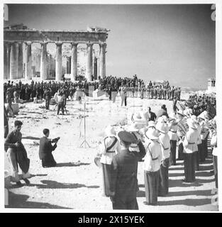 GREEK GOVERNMENT RETURNS TO ATHENS - The Greek Flag, carried by four Greek girls, in National costume, is prepared for hoisting over the Parthenon British Army Stock Photo