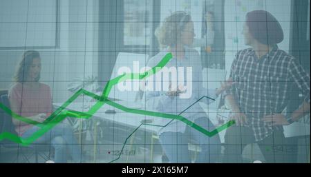 Image of financial data processing and green lines over business people working in office Stock Photo