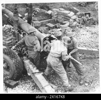 Gunney Shell A British Army crew loads a shell into the breech during gunnery ...