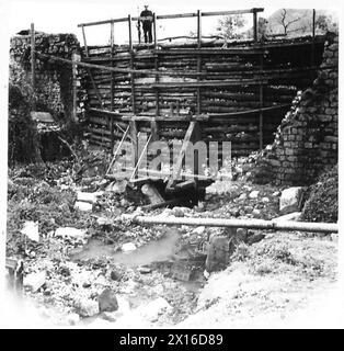 ITALY : AUTUMN FLOODS CAUSE ROAD DAMAGE - Route 6 Km.156. View from upstream of 4' x 3' timber box culvert blocked with storm debris which left uncleared would cause washout to improvised retaining wall British Army Stock Photo