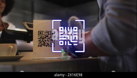 Image of qr code over biracial man paying in cafe with smartwatch Stock Photo