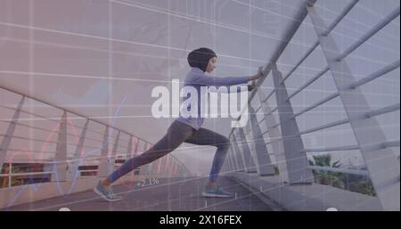 Image of graphs and circle with grid over biracial woman in hijab stretching on footbridge Stock Photo