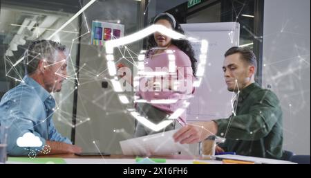 Image of lock with shield and connected dots over diverse colleagues discussing in office Stock Photo