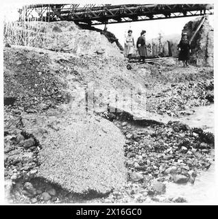 ITALY : AUTUMN FLOODS CAUSE ROAD DAMAGE - Large slabs of road metal swept downstream by 'washout' British Army Stock Photo