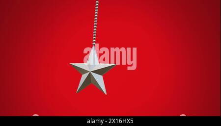 Image of hanging star swinging against red background Stock Photo