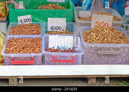 Organic fruit nuts piles plastic crates sold outside on a market stall Stock Photo