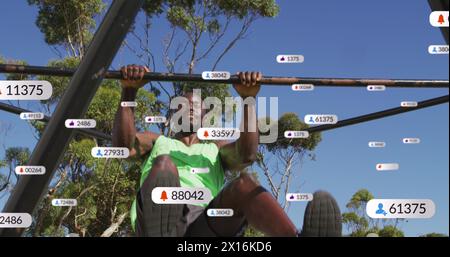 Image of media icons over african american sportsman Stock Photo