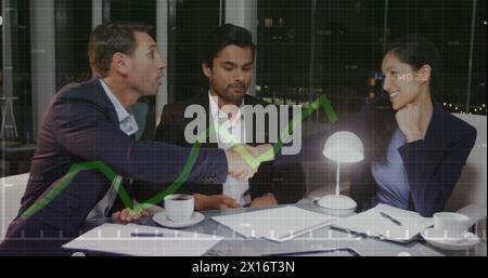 Two business people shaking hands in an office Stock Photo