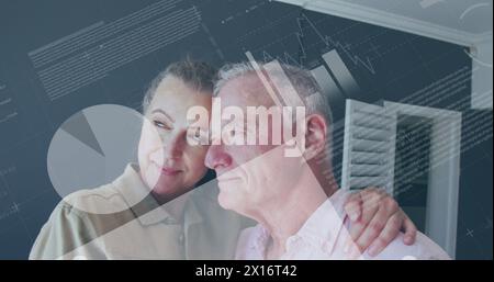 Image of statistical data processing over caucasian senior couple embracing each other at home Stock Photo