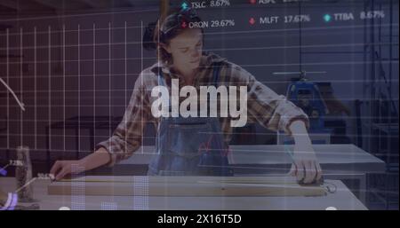 Image of financial data processing over woman working in workshop Stock Photo