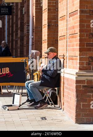Man playing saxophone for charity, Cornhill, Lincoln City, Lincolnshire, England, UK Stock Photo