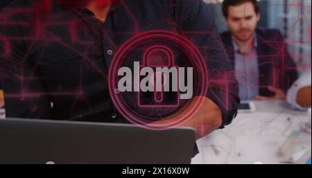 Image of security padlock and connections over biracial businessman using laptop in office Stock Photo
