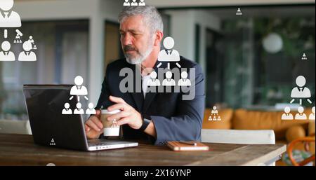 Image of flowcharts over caucasian man drinking coffee while working on laptop Stock Photo
