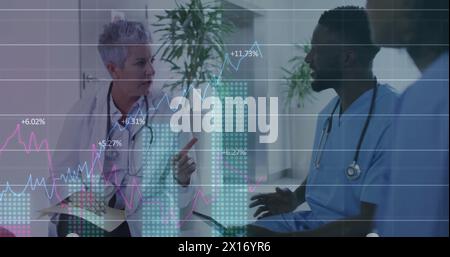 Image of multiple graphs with changing numbers, diverse doctors discussing in hospital Stock Photo