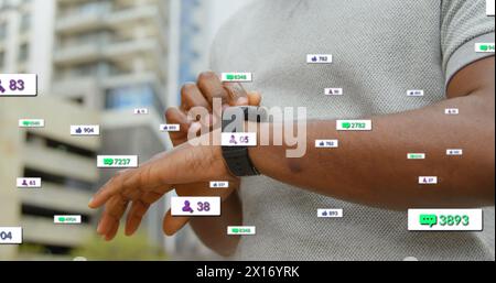 Image of notification bars over midsection of african american man scrolling on smartwatch Stock Photo