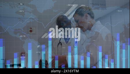 Image of graphs, changing numbers and map over diverse doctors discussing patients reports Stock Photo