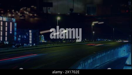Image of road traffic in city at night in fast motion with city lights and light trails in the foreg Stock Photo