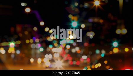 Image of road traffic in city at night with blurred city lights and colourful spots of light in the Stock Photo