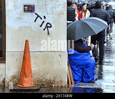 Glasgow, Scotland, UK. 15h April, 2024: UK Weather:  Wet and Windy in the city as people struggled on the shopping capital and style mile of Scotland, Buchanan Street. Credit Gerard Ferry/Alamy Live News Stock Photo