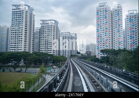 30.07.2023, Singapore, Republic of Singapore, Asia - View from a fully automated shuttle train of the Sengkang LRT line of typical HDB buildings. Stock Photo