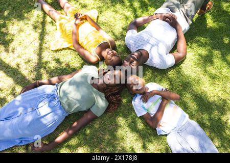 African American family lying on grass, enjoying sun Stock Photo