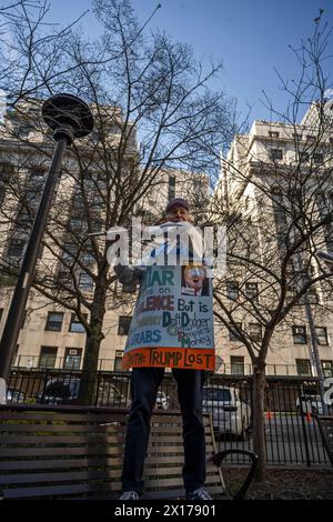 New York, USA. 15th Apr, 2024. New York, New York, USA Anti-Trump protester plays Star Spangled Banner on flute outside courthouse where jury selection is beginning in former president's trial on criminal charges of falsifying business records Credit: Joseph Reid/Alamy Live News Stock Photo