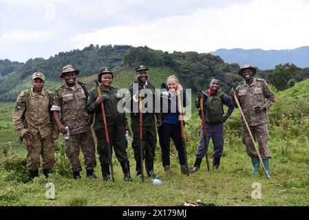 In a heartwarming moment captured for posterity, a diverse group of individuals, including a delighted tourist and several jubilant Bwindi workers, po Stock Photo
