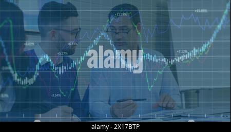 Image of financial data processing over two diverse businessmen discussing at office Stock Photo