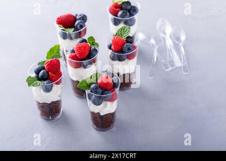 Chocolate mousse in cups topped with whipped cream and fresh berries Stock Photo