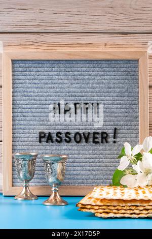 Happy Matza Happy passover. Metal goblet and traditional matzah on blue background ...