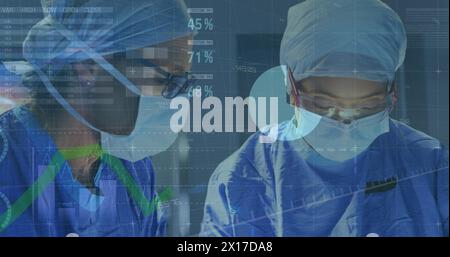 Image of statistical data processing over two female surgeons performing operation at hospital Stock Photo