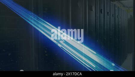 Image of glowing blue light trails over empty computer server room Stock Photo