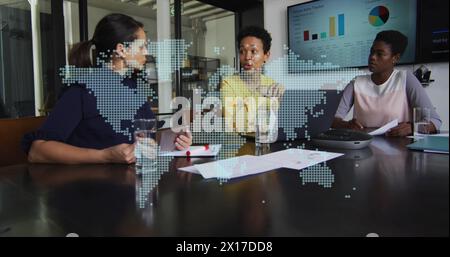 Image of world map with bitcoins over diverse business people talking in office Stock Photo
