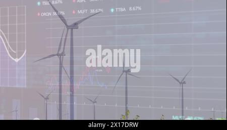 Image of graphs, trading boards and loading circles, windmill on green field against clear sky Stock Photo