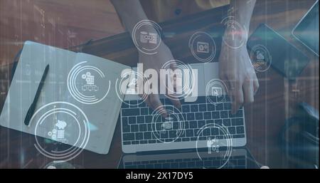 Image of media icons over caucasian woman taking notes in office Stock Photo