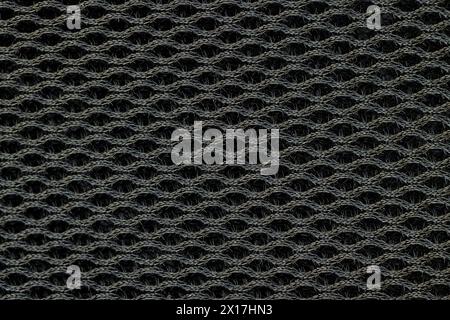 soft black ventilated mesh fabric with holes, black synthetic fabric for use in the manufacture of items Stock Photo