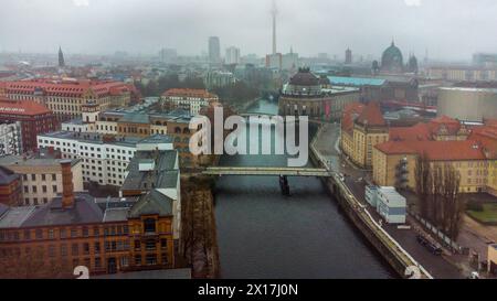 Awe Drone view on Weidendammer Brucke (bridge) and Ebertsbrucke over Spree river and  Bode-Museum (with Ukranina flag) in foggy Berlin. Berliner Ferns Stock Photo
