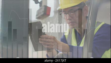 Image of statistic charts over asian male worker in warehouse Stock Photo