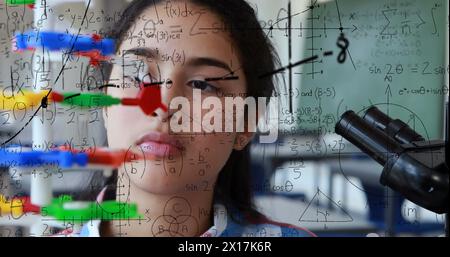 Image of mathematical formulae over student using microscope Stock Photo