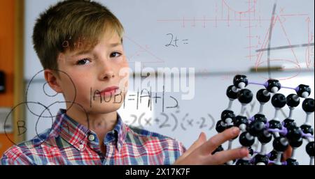 Image of mathematical formulae over smiling schoolboy Stock Photo