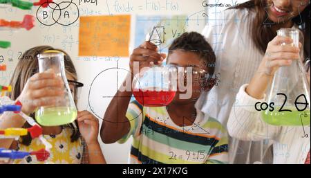 Image of mathematical formulae over pupils and teacher Stock Photo