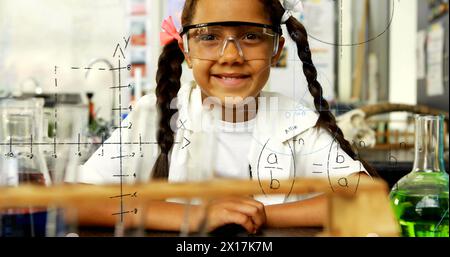 Image of mathematical formulae over smiling schoolgirl Stock Photo